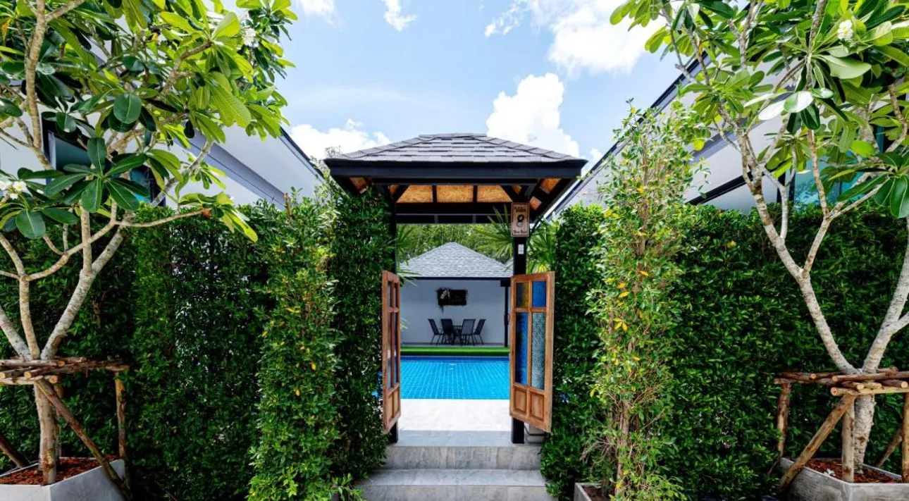 Lush garden entrance to private pool villa